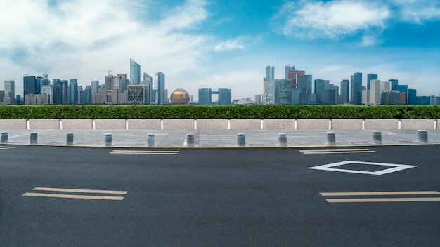 Panoramic skyline and empty asphalt road with modern buildings