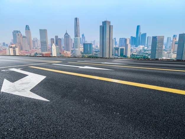 Panoramic skyline and empty asphalt road with modern buildings