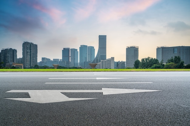 Panoramic skyline and empty asphalt road with modern buildings