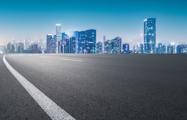 Panoramic skyline and empty asphalt road with modern buildings