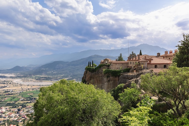 Panoramic view of ancient St Stephen Monastery with sheer cliff over Thessaly plain, Meteora, Greece