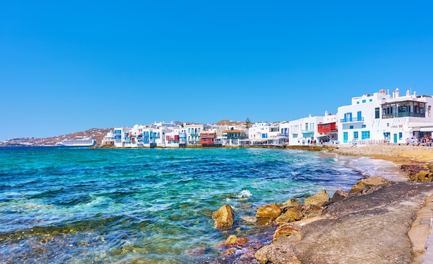 Panoramic view of the beach and houses by the sea in Mykonos Island in Greece - Greek landmark