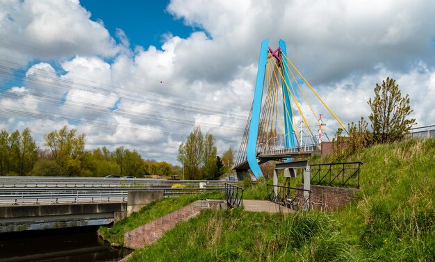 Panoramic view of bridge over field against sky