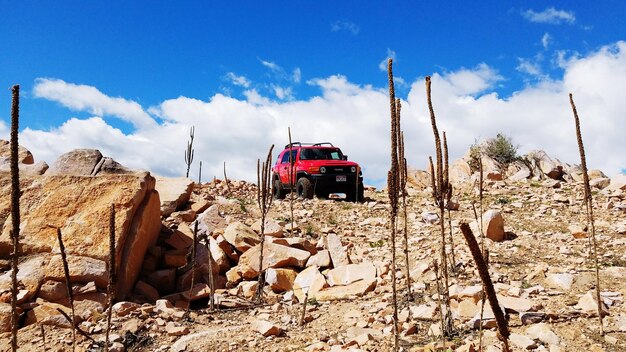 Panoramic view of cars on rock against sky