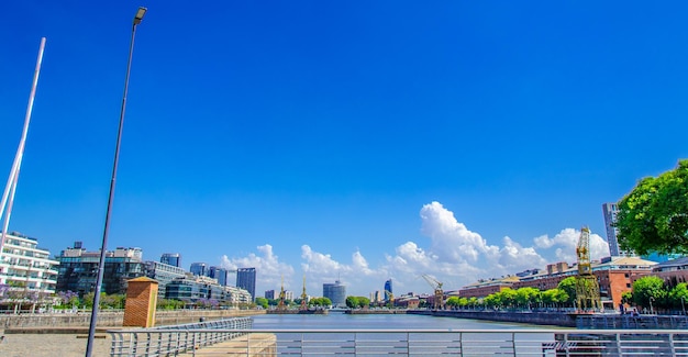 Panoramic view of city against clear blue sky