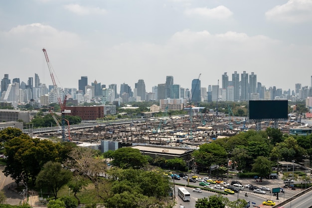 Panoramic view of cityscape and construction site in metropolis