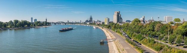 panoramic view of the cologne skyline at summer with cathedral and hohenzollern bridge. ideal for websites and magazines layouts