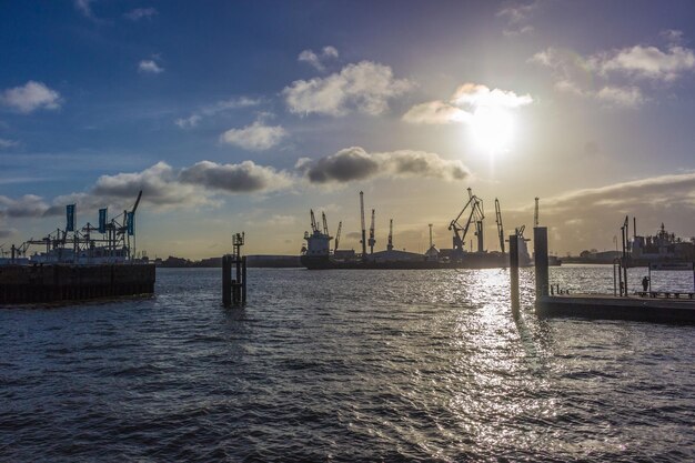 Panoramic view of commercial dock against sky