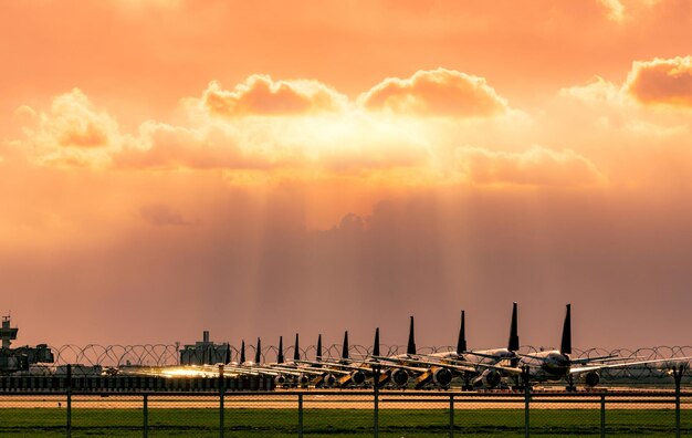 Panoramic view of factory against sky during sunset