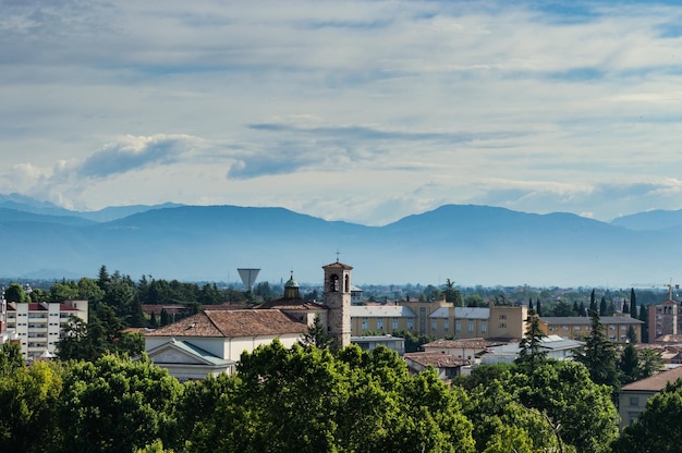 Panoramic view from above with a dome and roofs of the city of Udine Italy