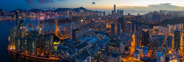 Panoramic view of illuminated buildings in city against sky at dusk