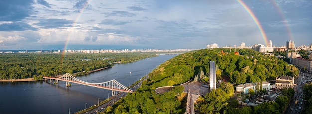 Panoramic view of kyiv city with a beautiful rainbow over the city