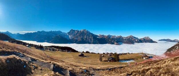 Panoramic view of landscape and mountains against clear blue sky