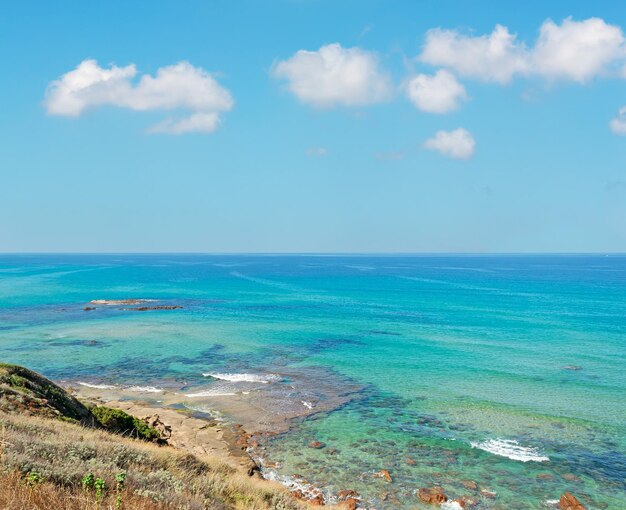 Panoramic view of Lu Bagnu coastline on a sunny day