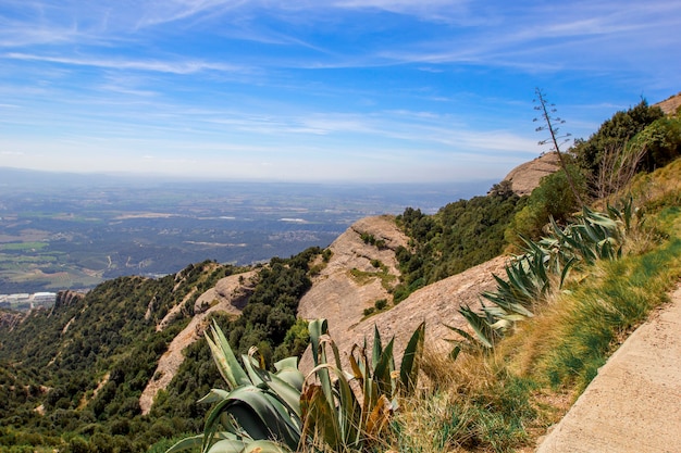 Panoramic view of mountain landscape from top of hill on spring sunny day. Montserrat mountains, Spain.