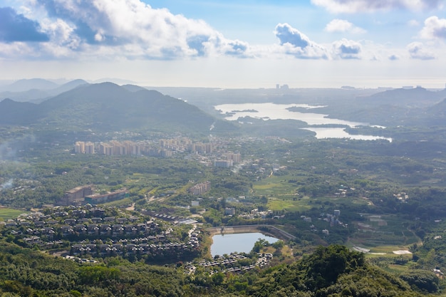 Panoramic view to mountains, tropical forest, Yanoda Park and Sanya city. Rainforest cultural tourism zone Yanoda, Hainan island, Yalong Bay Tropical Paradise Forest Park. China.