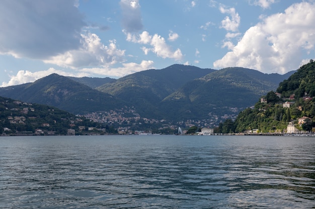 코모 호수(lago Di Como)의 탁 트인 전망은 이탈리아 롬바르디아의 빙하 기원 호수입니다. 여름날과 극적인 푸른 하늘