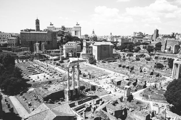 Panoramic view of Roman forum, also known by Forum Romanum or Foro Romano from Palatine Hill. It is a forum surrounded by ruins of ancient government buildings at center of city of Rome