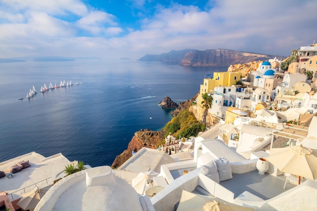 Panoramic view of Santorini The famous town of Oia in the morning A line of sailing yachts at sea Good vacation Oia Santorini Greece