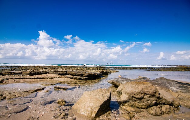 Panoramic view of sea against blue sky