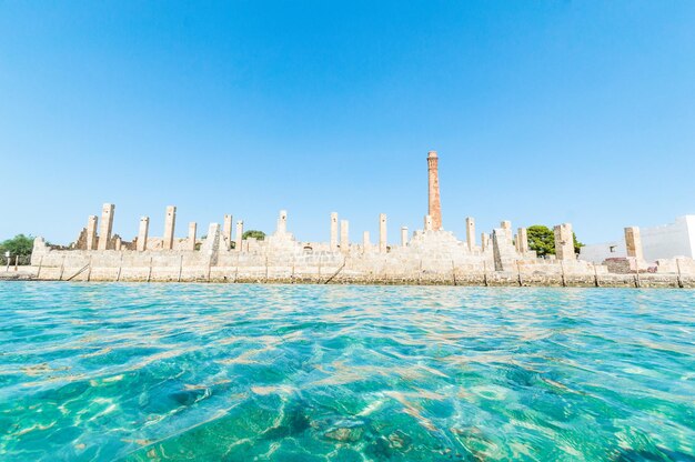 Panoramic view of sea and buildings against clear blue sky