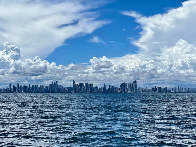 Panoramic view of sea and buildings against sky