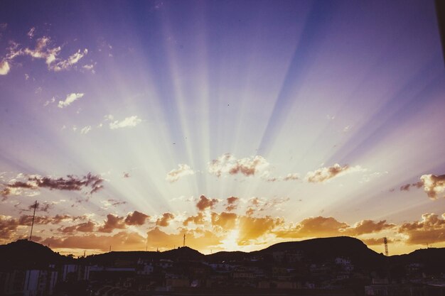 Panoramic view of silhouette buildings against sky at sunset