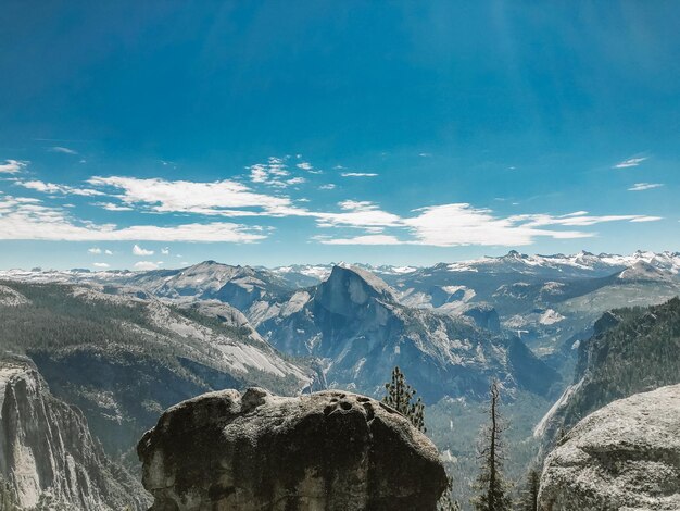 Panoramic view of snowcapped mountains against blue sky