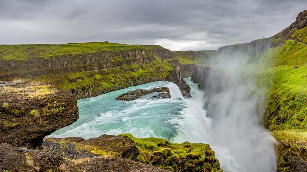 Photo panoramic view over waterfall wonder gullfoss in south iceland golden circle at summer with dramatic sky