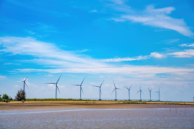 Panoramic view of wind farm at sea with high wind turbines for generation electricity with copy space at tra vinh viet nam green energy concept eco concpept