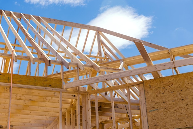 Panoramic view of wooden frame house under construction roof truss system beams