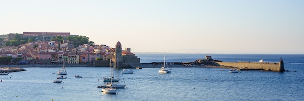 panoramic views of a medieval port with boats on the water. Travel concept