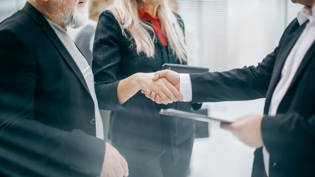 Panoramisch beeld zakenpartners schudden elkaar de hand tijdens onderhandelingen