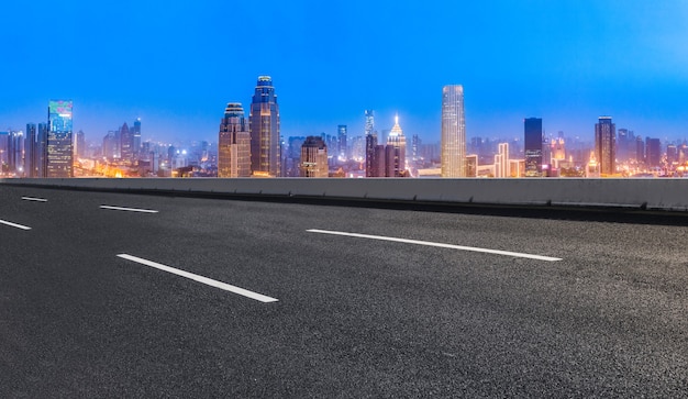 Panoramische skyline en lege asfaltweg met moderne gebouwen