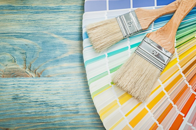 Pantone fan paint brushes on wooden board construction concept