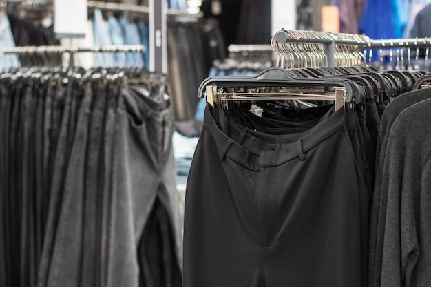 Pants hanging on hangers in a store