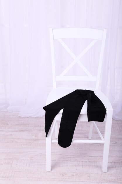 Photo pantyhose on wooden chair in room