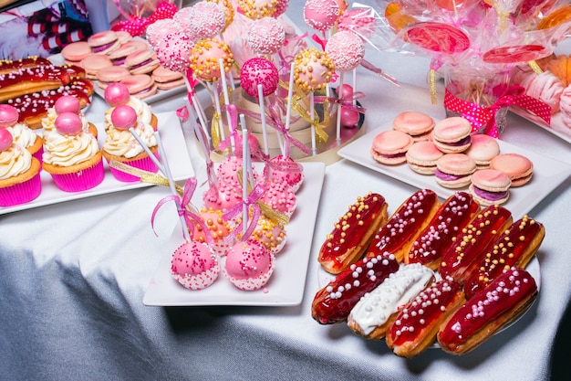 Pap-cakes, eclairs, cakes, and macaroni on the table for sweets