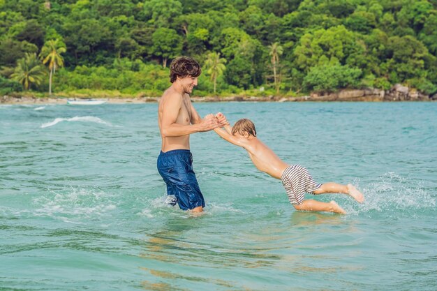 Papa speelt met zijn zoon in de zee