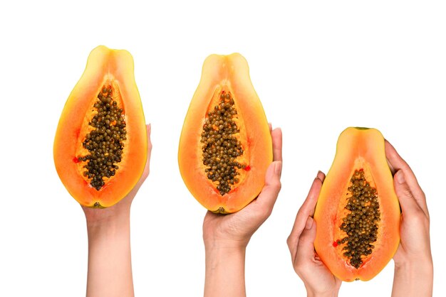 Papaya fruit isolated on a white background in woman hands Tropical fruit Half papaya