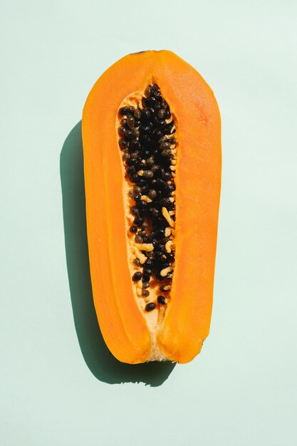 Papaya fruit on a orange background tropical fruit half papaya