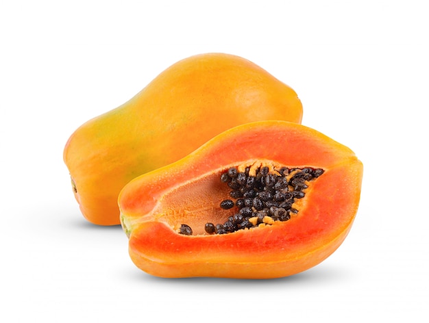 Papaya fruit with seeds on white wall