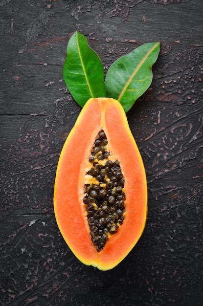 Papaya fruit on a wooden background Tropical Fruits Top view Free space for text