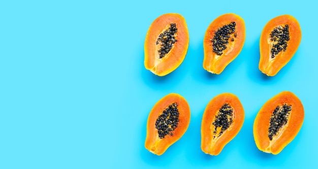 Papaya fruits on blue background. top view