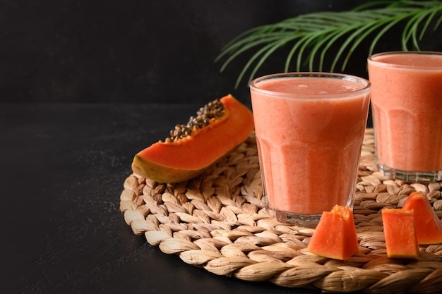 Papaya lassi in glass on gray background