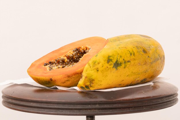 A papaya on a plate with a white background