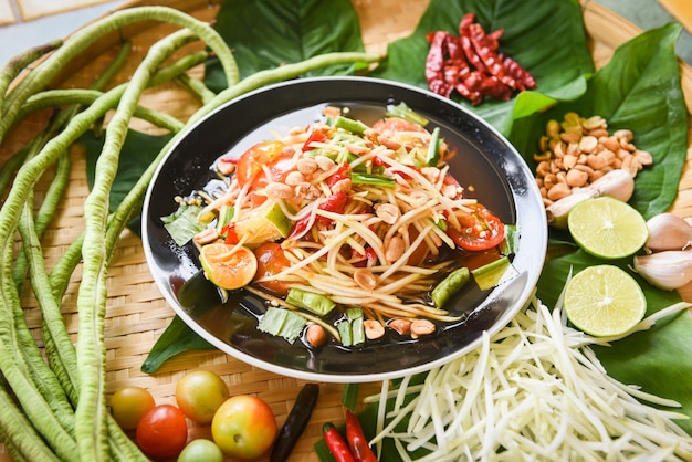 Papaya salad served on wooden dining table