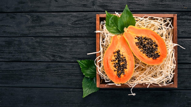 Papaya Tropical Fruits On a wooden background Top view Copy space