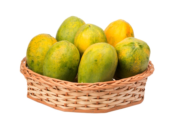 Papayas in wicker basket on white background