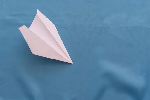 Paper airplane on a blue background